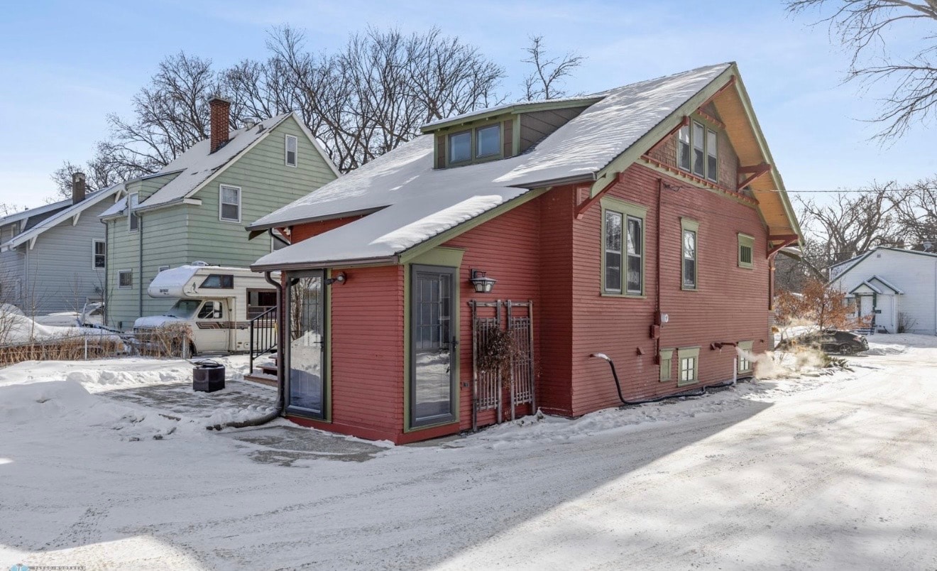 Exterior — red craftsman home with sunroom addition, winter
