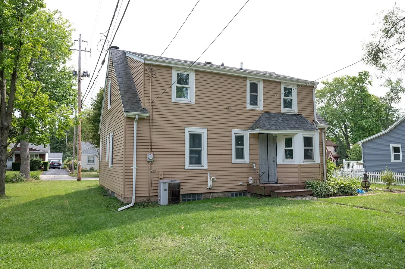 Exterior — tan two-story home side view with lawn