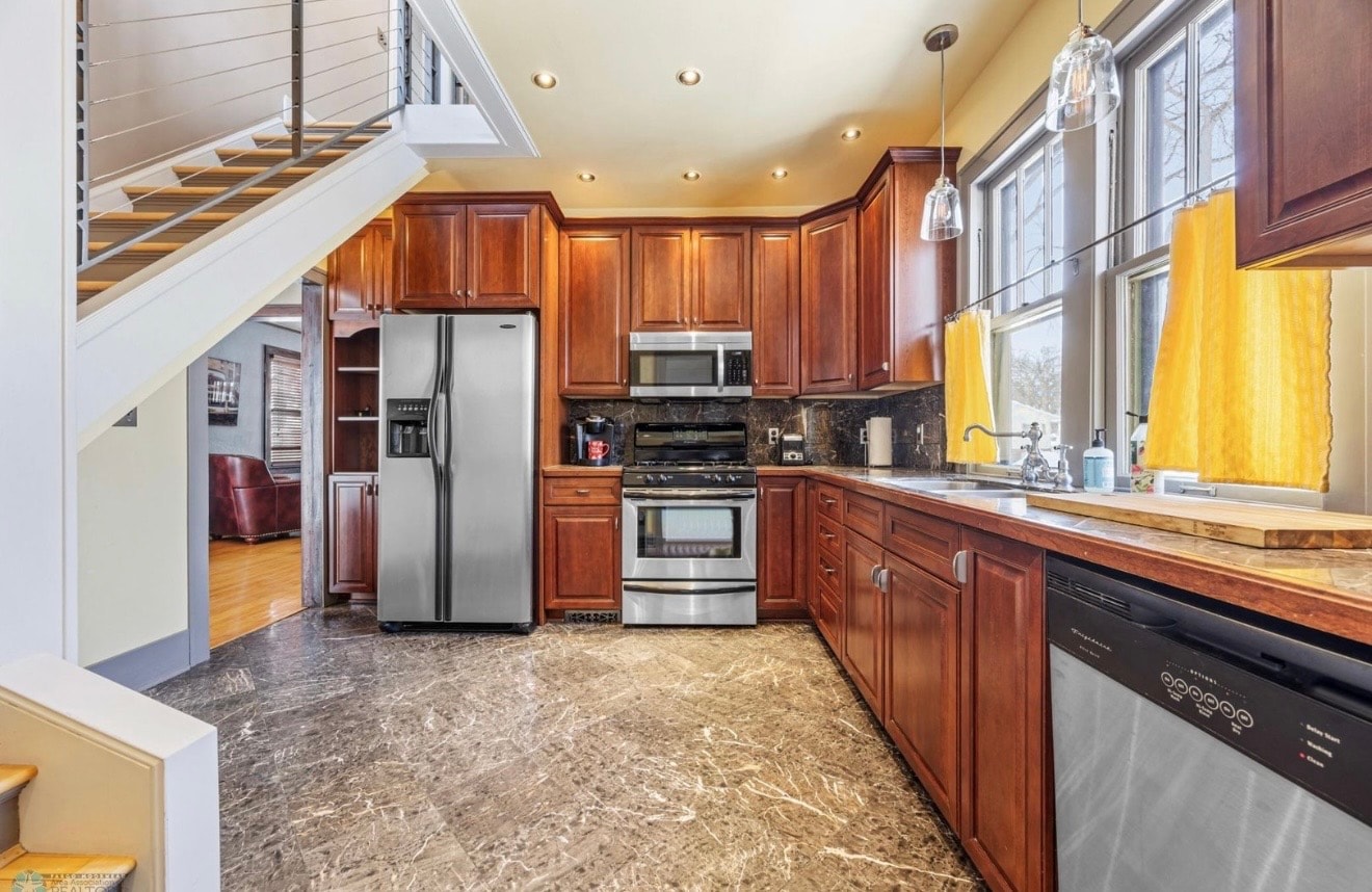 Kitchen — cherry cabinets with stainless appliances and marble floors