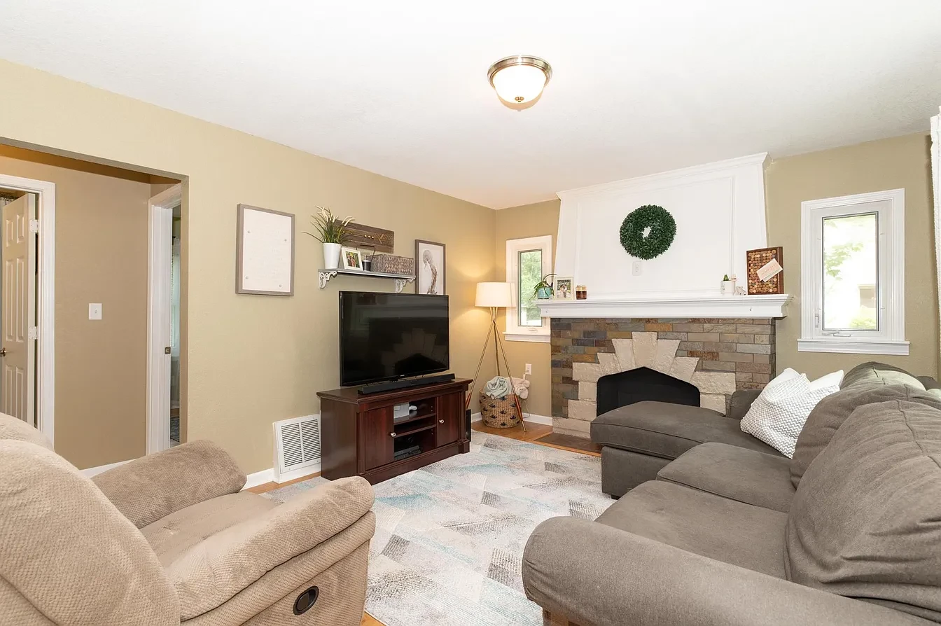Living room — stone fireplace with sectional sofa and recliner