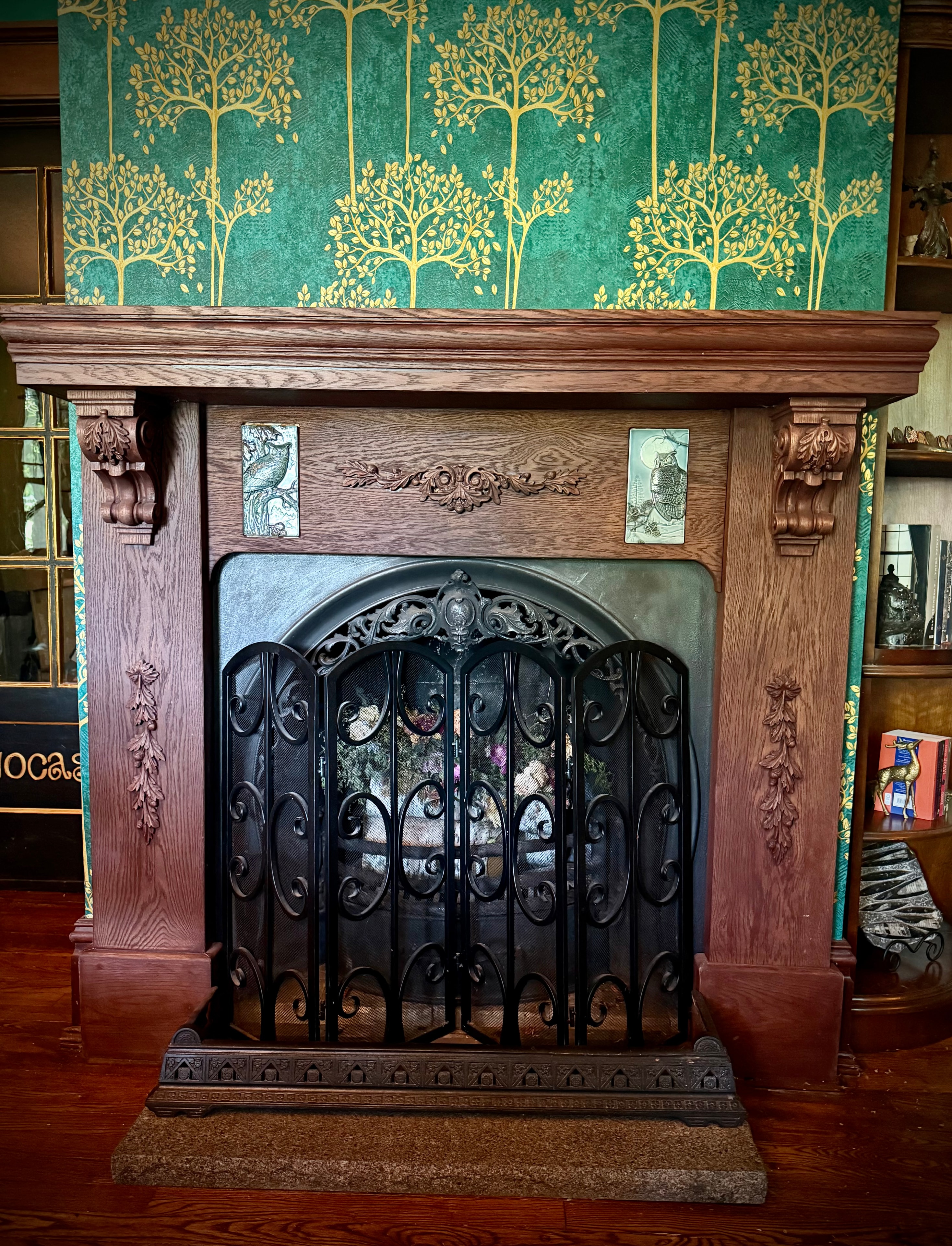 Custom built oak fireplace with handcrafted owl tiles and 13th century cast-iron surround